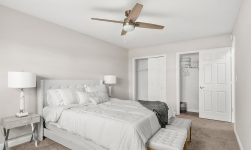 a bedroom with a bed and two nightstands