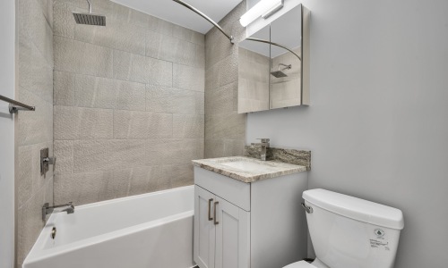a bathroom with a tub, sink and toilet